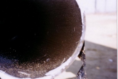 Pipeline cut out prior to cleaning. Note the oil layer.
