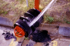 Cleaning sludge from brush tool